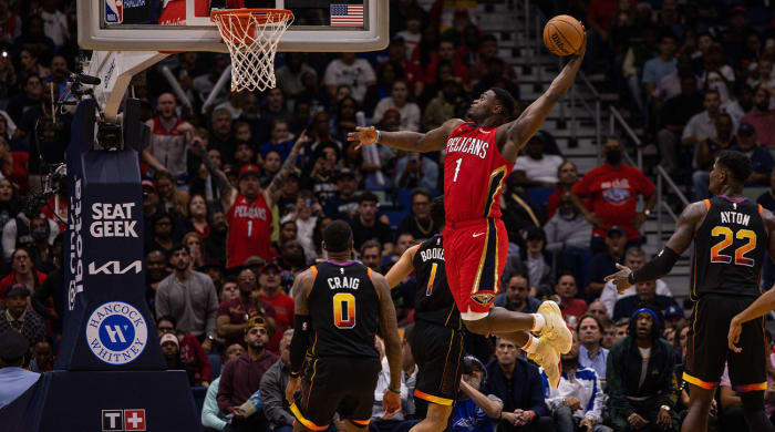 Dec 9, 2022; New Orleans, Louisiana, USA; New Orleans Pelicans forward Zion Williamson (1) dunks the ball against Phoenix Suns guard Devin Booker (1) and forward Torrey Craig (0) during the second half at Smoothie King Center.